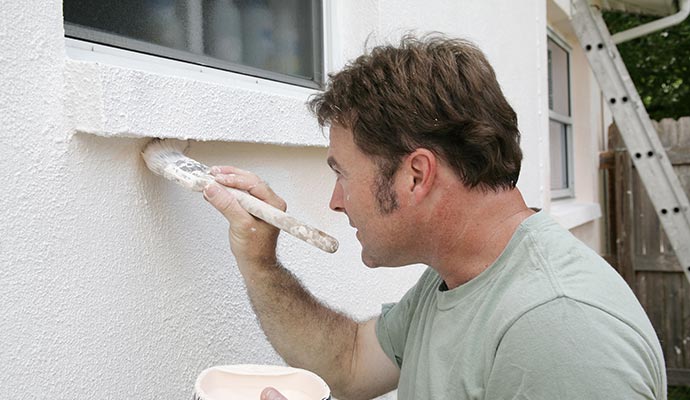 Commercial painter painting a wall