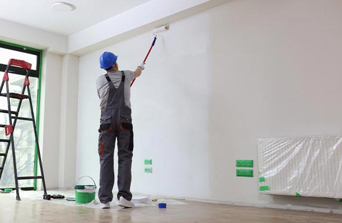 Worker painting in the room