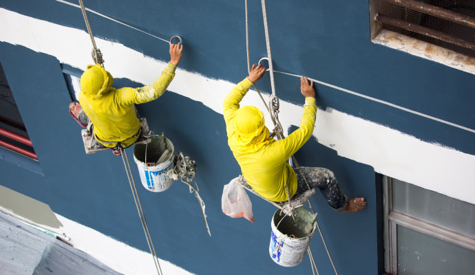 A couple of professionals repainting a commercial property