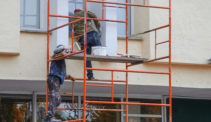 professional painters working on scaffolding