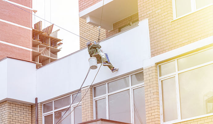 Painter on a building painting