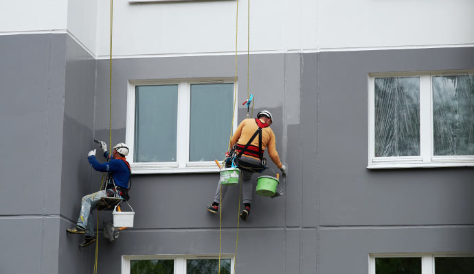 professional team paintaing exterior of a building