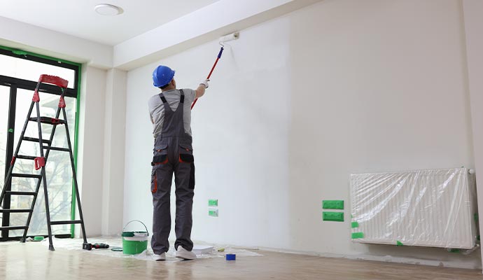 a painter painting commercial building's interior