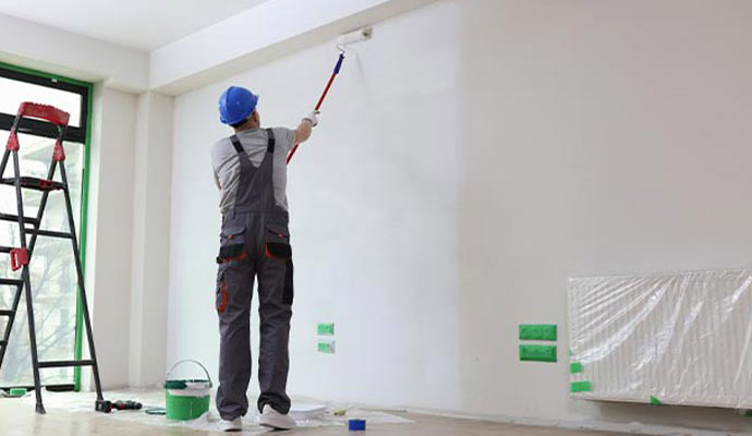 Person painting an interior space