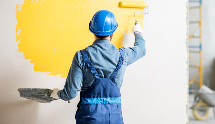 professional worker painting a wall